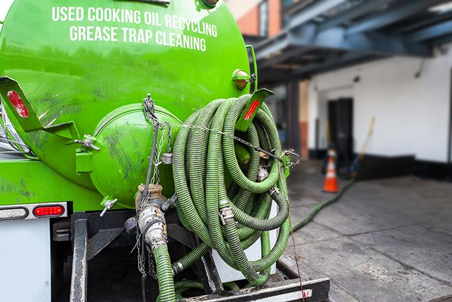 a vacuum truck pumping out a large underground grease trap in Bayport, MN